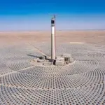 a tower in a field of solar panels